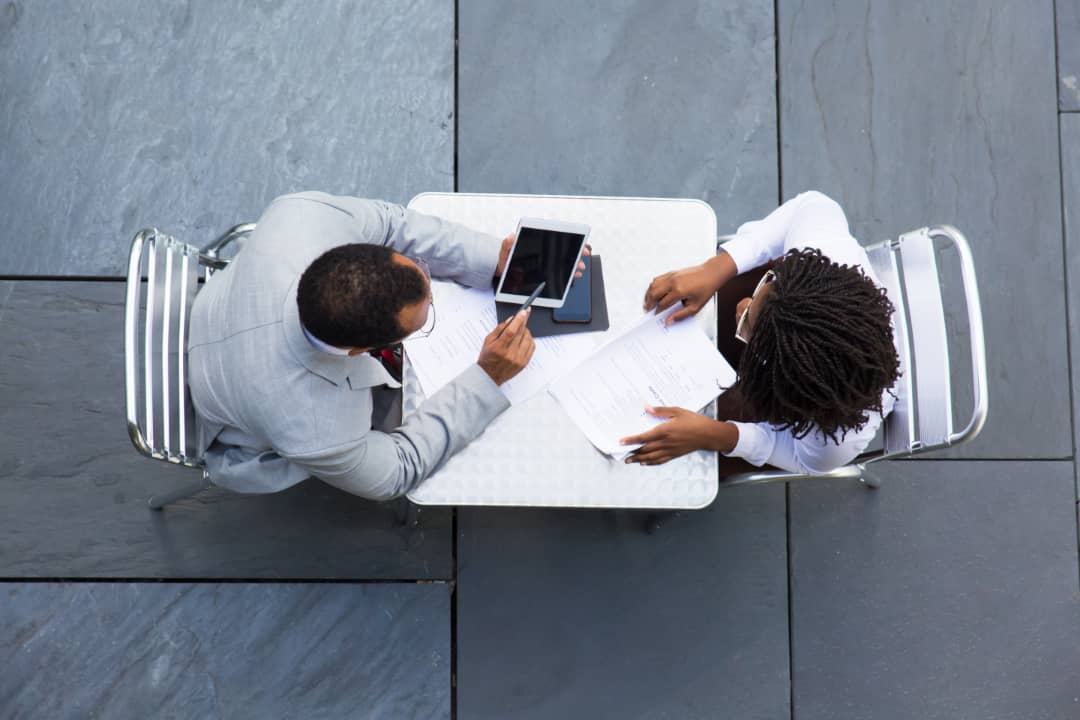 Consultant and parent discussing homeschooling plans at a table
